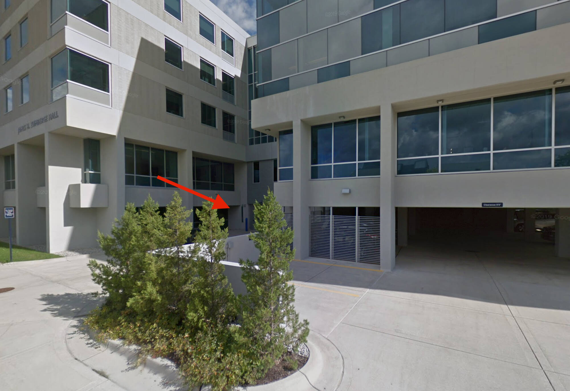 The west side of Zumberge Hall, where the service and parking garage entrances are located. A red arrow points to the service entrance.